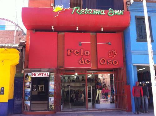 a store with a red sign on the front of it at Hostal Retama Inn in Huancayo