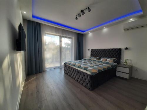 a bedroom with a bed and a large window at Stars lux room in Belgrade