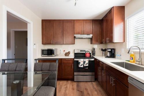 a kitchen with wooden cabinets and a counter top at Posh home near Santana Row for vacation/business in San Jose