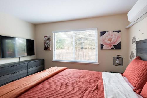 a bedroom with a large bed and a television at Posh home near Santana Row for vacation/business in San Jose