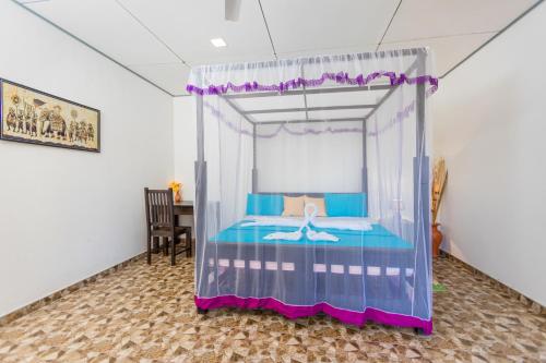a bedroom with a canopy bed with a swan on it at Rock Violet Lakefront Cabanas & Restaurent in Tangalle