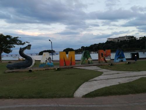 a park with a sign that says m and a snake at Las colinas de Samaná in Santa Bárbara de Samaná