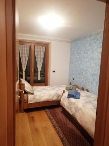 a bedroom with two beds and a mirror at Casa Laura in Valdidentro