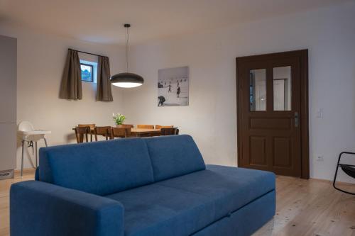 a blue couch in a living room with a table at Tschardakenhof Appartements in Lutzmannsburg