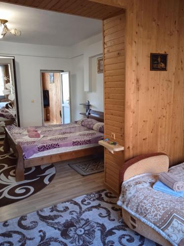 a bedroom with two beds and a mirror at Карпатські ночі in Yaremche