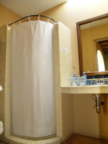a bathroom with a shower curtain and a sink at Hotel Ana Catalina and Suites in San Miguel de Allende