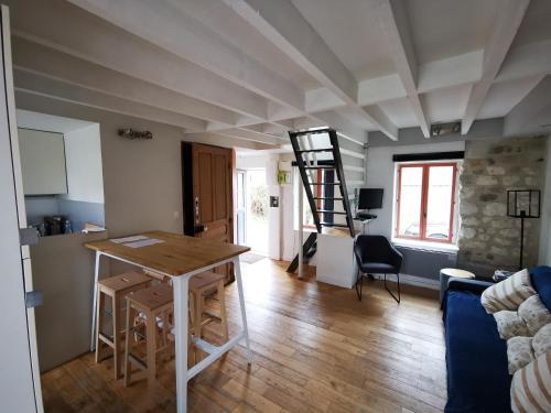 a kitchen and living room with a table and a ladder at Maison de pêcheur Wissant plein centre in Wissant