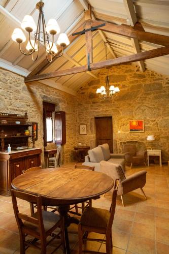a living room with a wooden table and a couch at Quinta De Vila Nova - Agroturismo in Monção