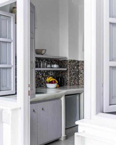 a kitchen with a counter with a bowl of fruit at Nefeli Homes - Adults Only in Imerovigli