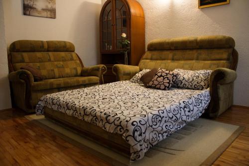 a living room with a couch and a chair at Apartman Lotus in Kiseljak