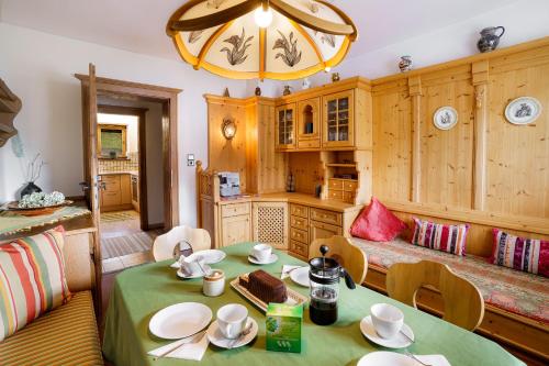 a kitchen with a table with a cake on it at Haus Seinader by Alpine Host Helpers in Kirchberg in Tirol