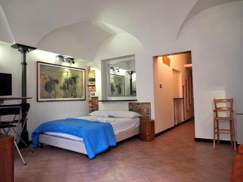 a bedroom with a bed with a blue blanket at LOVINGENOA DUCALE in Genoa