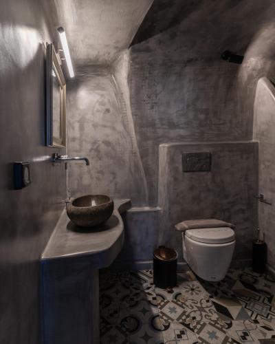 a bathroom with a sink and a toilet at Nefeli Homes - Adults Only in Imerovigli