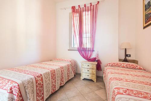 a room with two beds and a window at Villa Nepole in Torre Vado