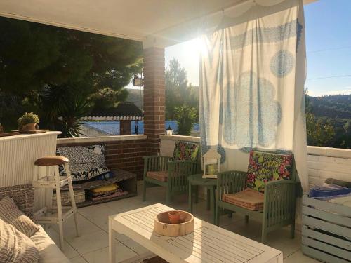 a patio with chairs and a table and a window at Charming villa near Tortosa with private pool in Tortosa