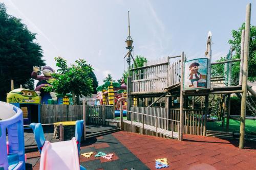 a park with a playground with a roller coaster at Hotel De Kalvaar in Ninove