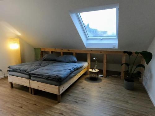 a bedroom with a bed in a room with a window at Neubau 2-Zimmerwohnung in Hochdorf in Hochdorf