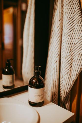 a bottle of soap sitting on top of a bathroom sink at Ylämaja - with a stunning view in Ruka