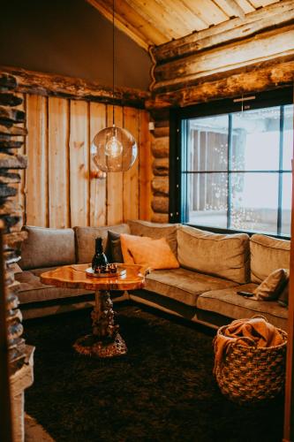 a living room with a couch and a table at Ylämaja - with a stunning view in Ruka