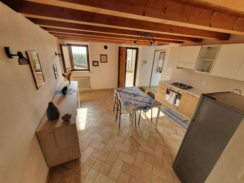 ein Wohnzimmer mit einem Tisch und einer Küche in der Unterkunft L'Antico Granaio in Negrar