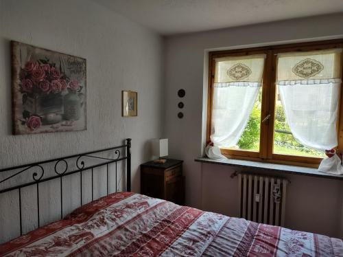 a bedroom with a bed and a window at Soleil in Morgex