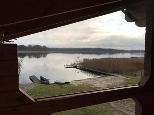 a view of a lake from a window at Берег Світязя in Svityazʼ