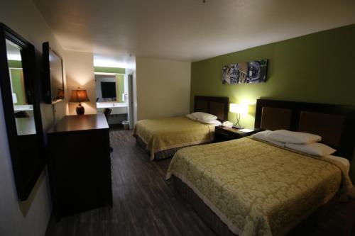 a hotel room with two beds and a desk at Rice Hill Inn in Oakland
