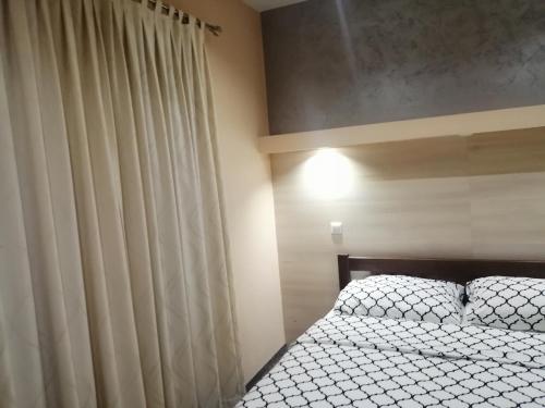 a bedroom with a bed and a window with a curtain at Motel Calypso Travnik in Travnik