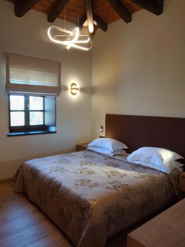 a bedroom with a large bed and a window at Mystras Grand Palace Resort & Spa in Mystras