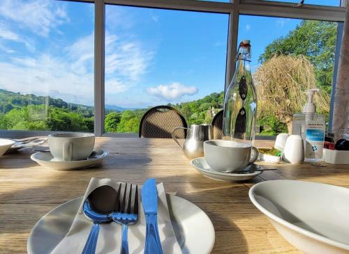 a wooden table with plates and utensils on it at The Mortal Man Inn in Troutbeck