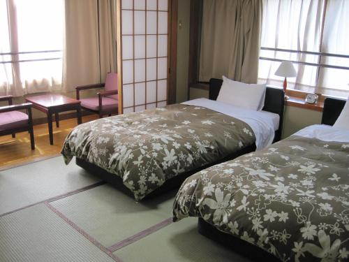 Кровать или кровати в номере Hotel Viva Nikko