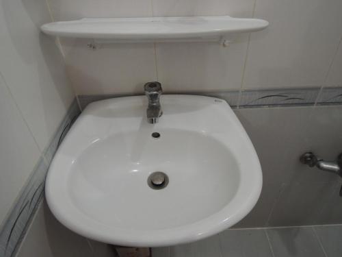 a white toilet seat in a small bathroom at Vy Khanh Guesthouse in Ho Chi Minh City