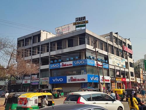 a building on a busy city street with cars at Hotel Newyork Inn in Anand