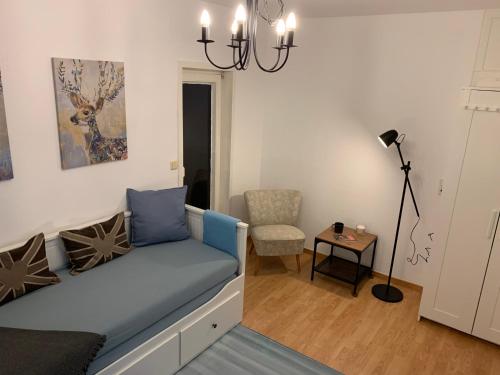 a living room with a couch and a chair at Haus am Stadtrand mit super Verbindung in die City in Kassel
