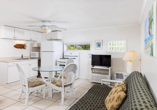 a living room with a couch and a table and chairs at Gulf View Waterfront Resort in Marathon
