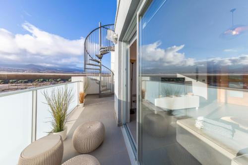 a balcony with a view of the desert at MEDANO4YOU The Casa Celou Penthouse in La Tejita