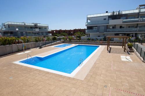 a swimming pool on the roof of a building at MEDANO4YOU The Casa Celou Penthouse in La Tejita