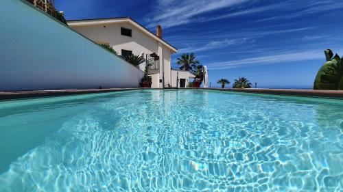 a swimming pool in front of a house at Al 33 Giri in Cefalù
