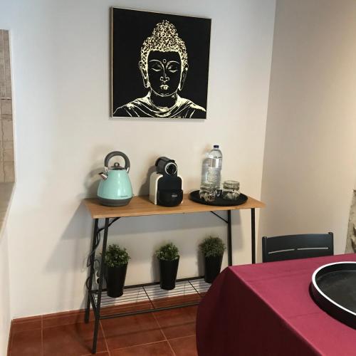 a table with a teapot on top of it at Casal das Nogueiras, casas rurais de charme agradáveis e acolhedoras in Arrimal