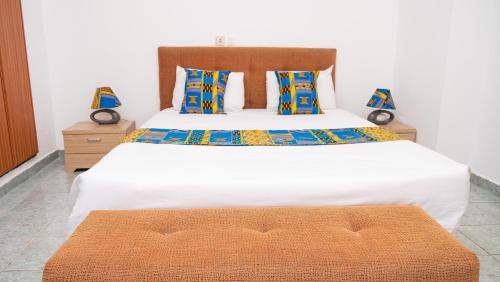 Postel nebo postele na pokoji v ubytování Hotel Djigui