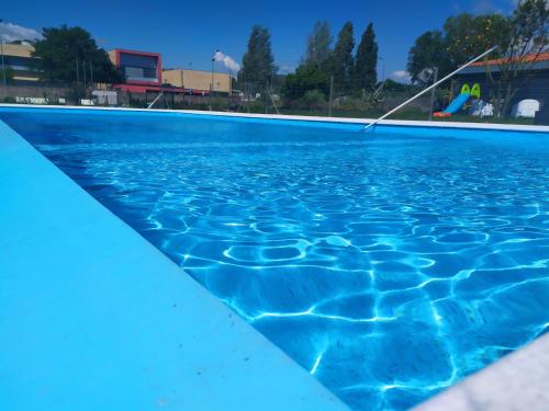 an empty swimming pool with blue water at Viana do Castelo Home in Viana do Castelo
