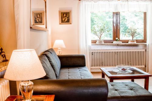 a living room with a couch and a table at Apartments Haus Martin in Bayerisch Eisenstein