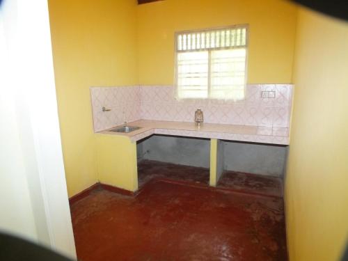 a bathroom with a sink and a window at Arogya Resort in Ambalangoda