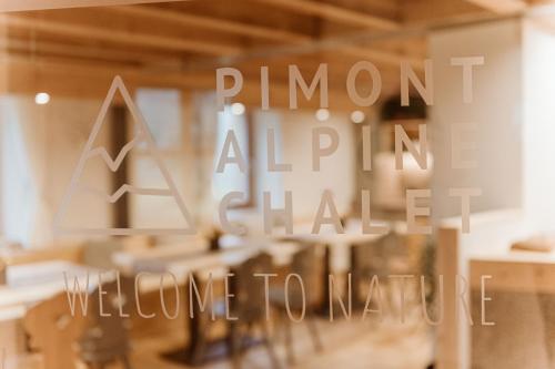a sign for a room with tables and chairs at Pimont Alpine Chalet in Madonna di Campiglio