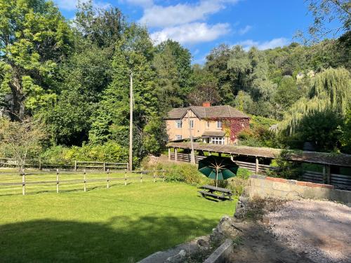 a large house with a large yard with a green lawn at Garden House in Nailsworth