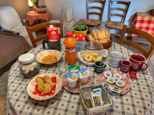 a table topped with plates of food and drinks at AL CORNIOLO in Zerba