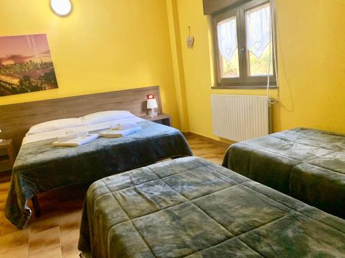 Ein Bett oder Betten in einem Zimmer der Unterkunft Hotel Miramonti Seulo Turismo Rurale