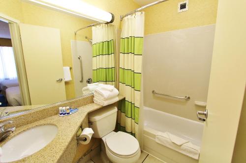 a bathroom with a toilet a sink and a bathtub at Baymont by Wyndham Flagstaff in Flagstaff