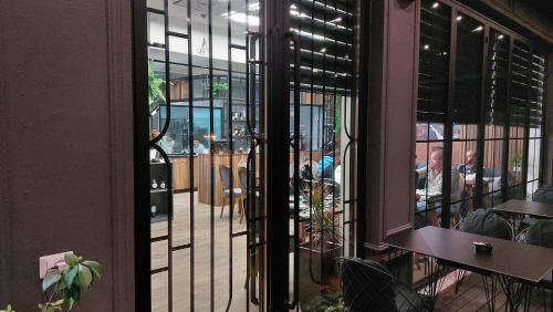 an open door to a restaurant with people sitting at tables at Bujtina Xhabakja in Belsh-Qendra