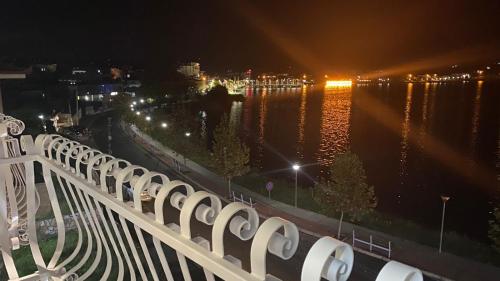 a view of the water from a balcony at night at Bujtina Xhabakja in Belsh-Qendra